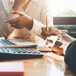 A couple signing papers to divide their assets during divorce proceedings.