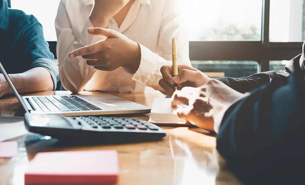 A couple signing papers to divide their assets during divorce proceedings.
